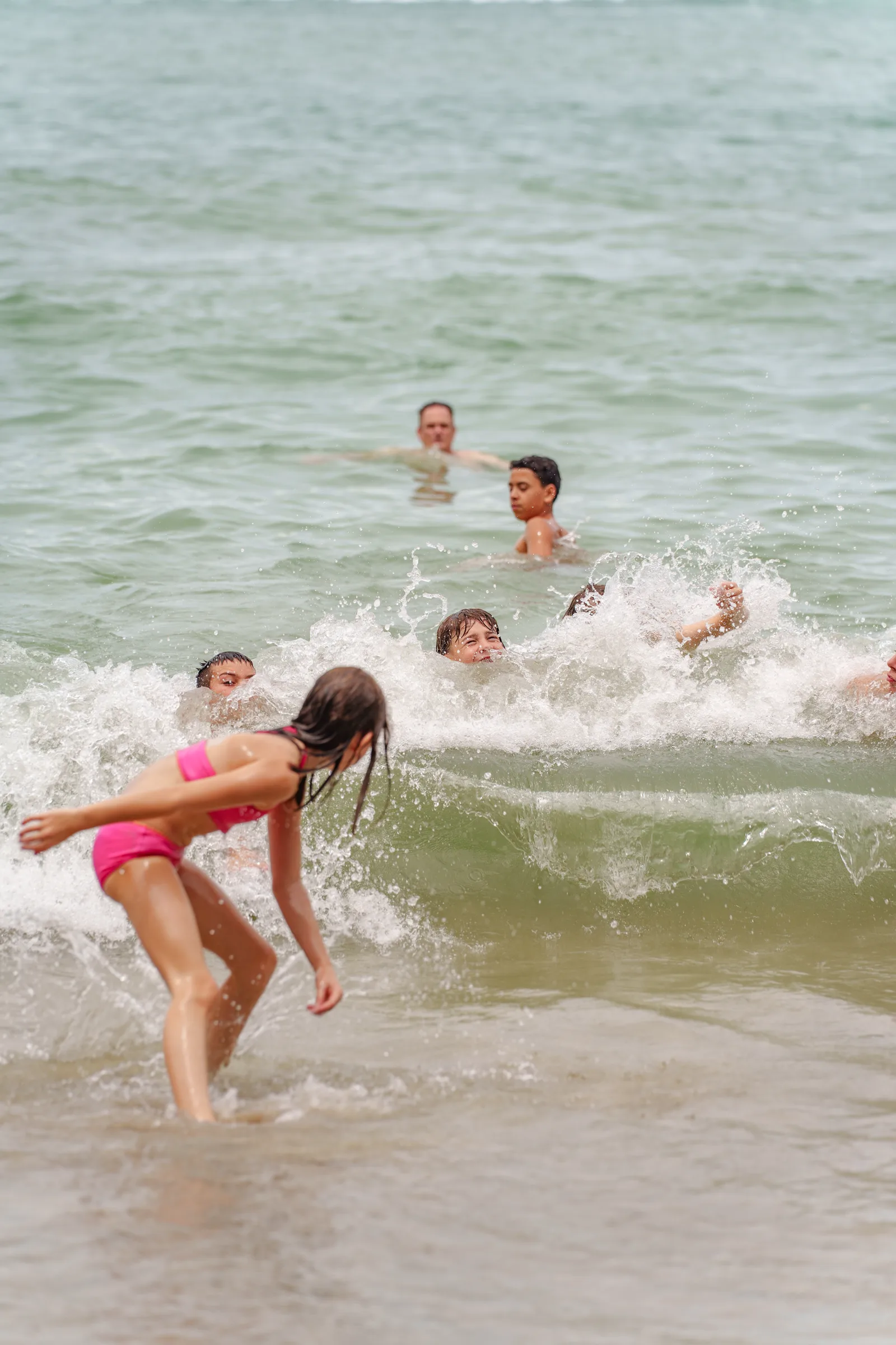 Kids playing in the Pacific surf at Manuel Antonio
