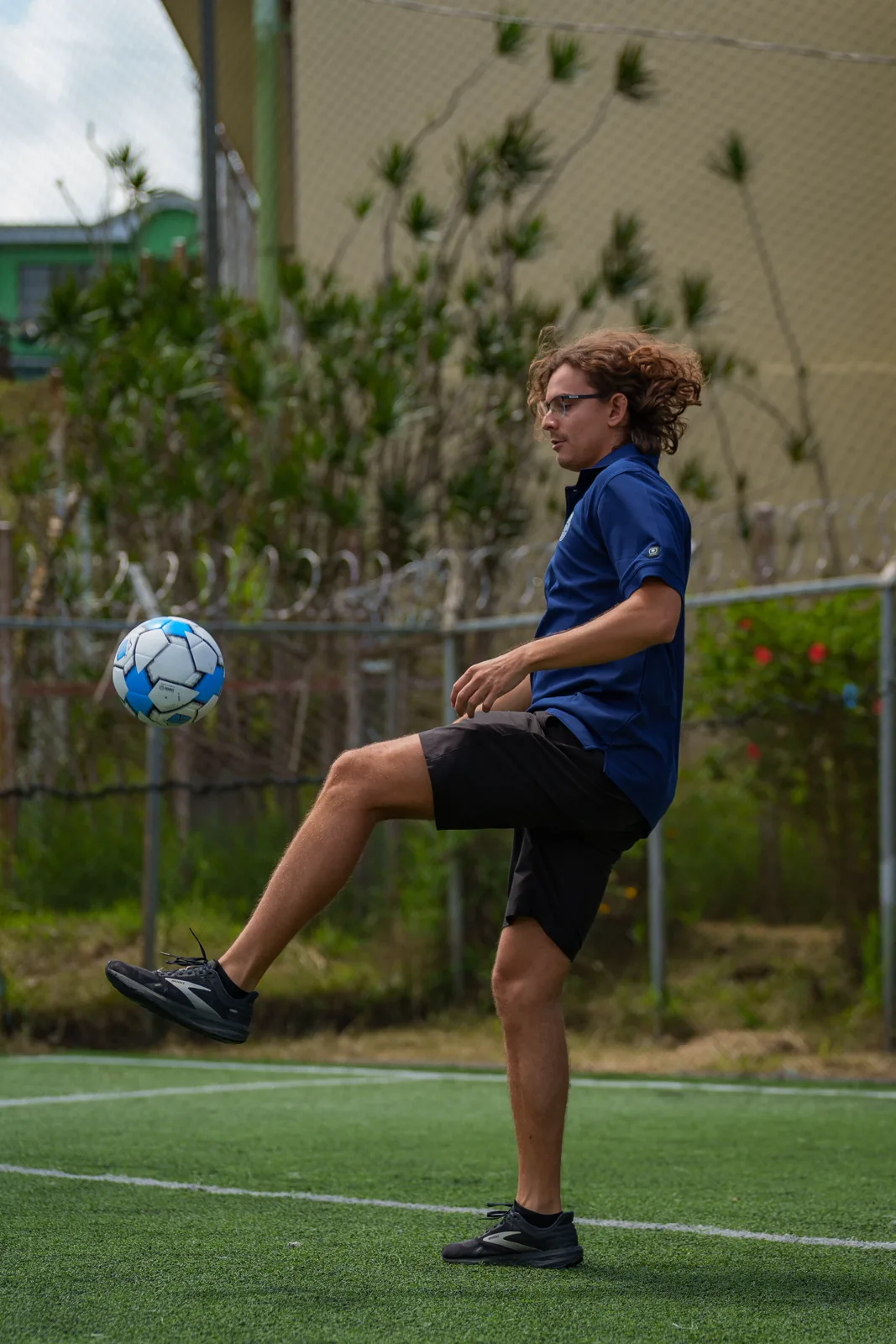 Lewis Teeple juggling a ball on a pitch in Costa Rica