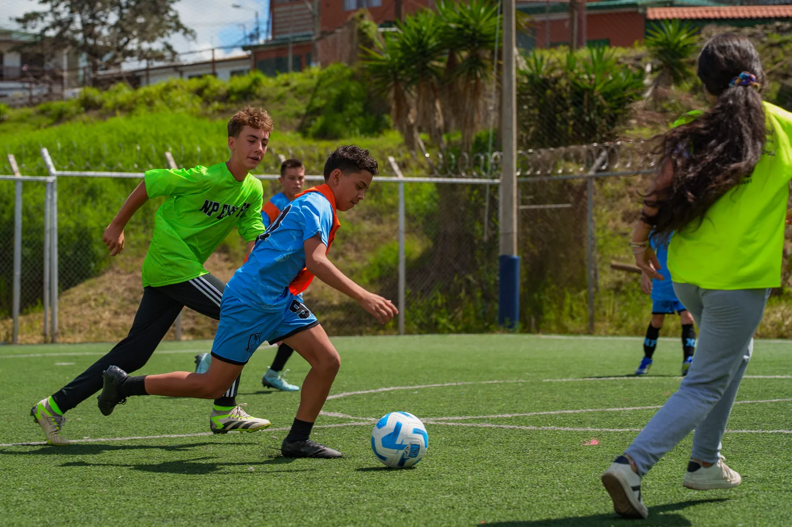 Visiting player shielding the ball from a defender during a match in Costa Rica