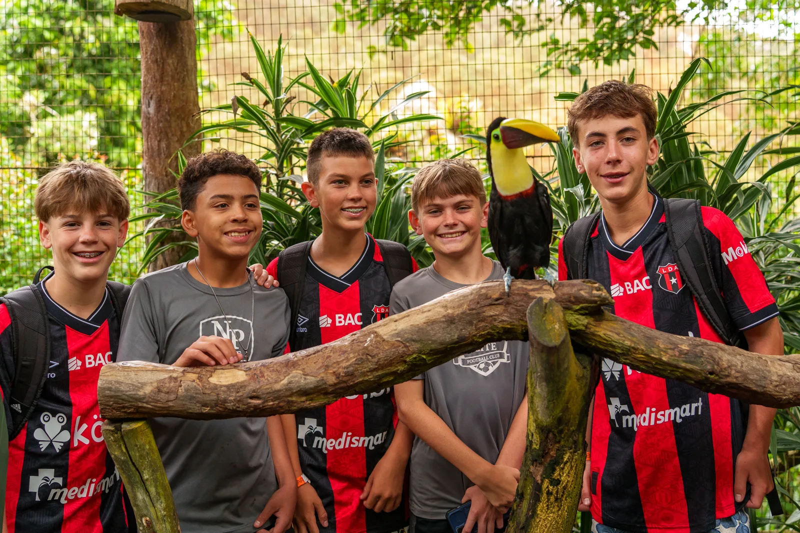Players in Alajuelense kits meeting a toucan